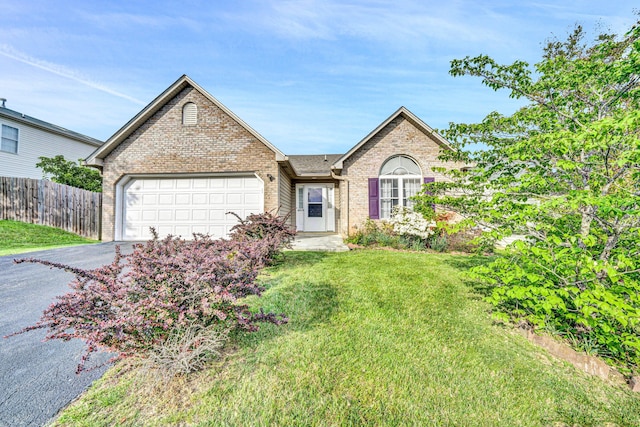 6815 Cee St, Roanoke, VA 24019 - single story home featuring a front yard, a garage, driveway, brick siding, and fence