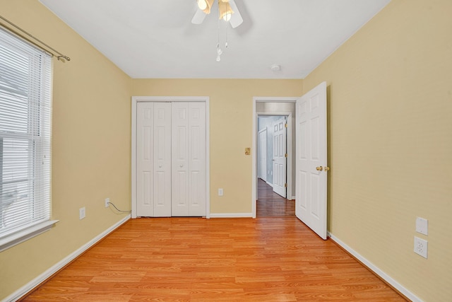 6815 Cee St, Roanoke, VA 24019 - unfurnished bedroom featuring a closet, baseboards, light wood-style flooring, and multiple windows
