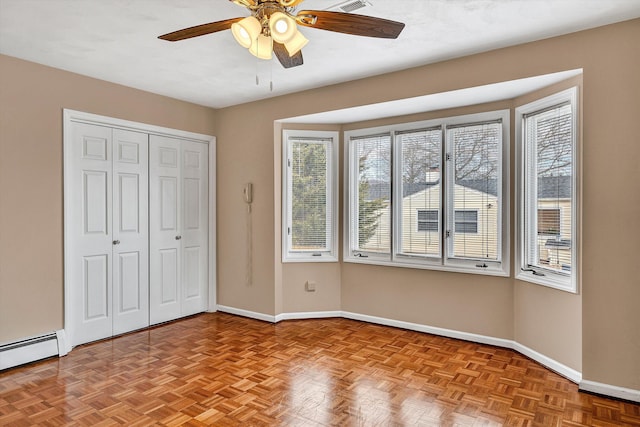 1714 Orchard Dr, Salem, VA 24153 - unfurnished bedroom with baseboard heating, a closet, ceiling fan, and baseboards
