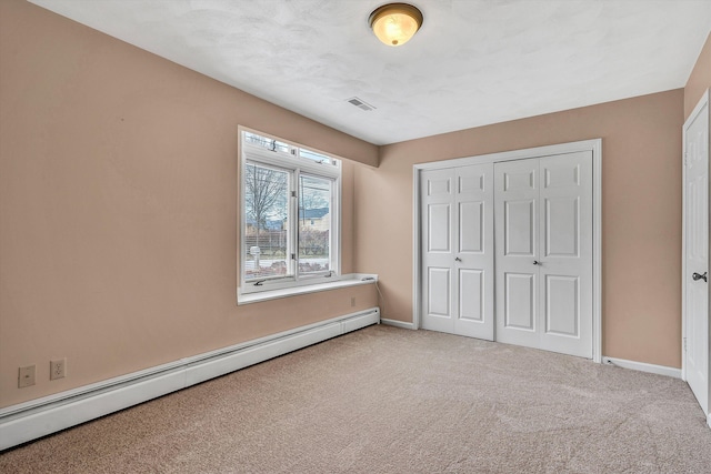 1714 Orchard Dr, Salem, VA 24153 - unfurnished bedroom featuring a closet, baseboards, visible vents, baseboard heating, and carpet floors