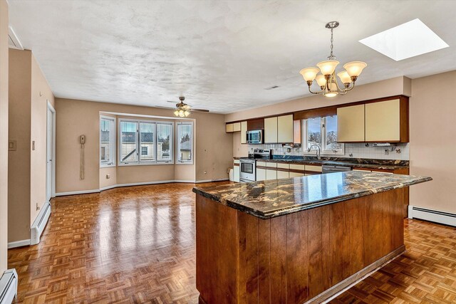 1714 Orchard Dr, Salem, VA 24153 - kitchen featuring baseboard heating, a skylight, appliances with stainless steel finishes, and tasteful backsplash