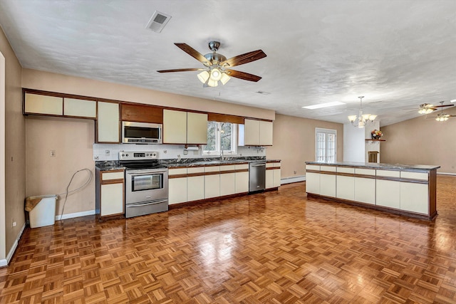 1714 Orchard Dr, Salem, VA 24153 - kitchen featuring ceiling fan with notable chandelier, dark countertops, visible vents, and stainless steel appliances