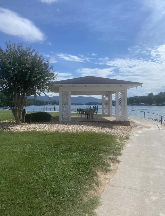 surrounding community featuring a lawn, fence, and a gazebo