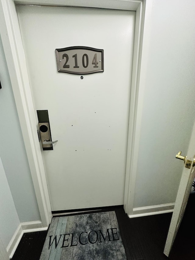 interior details with baseboards and wood finished floors