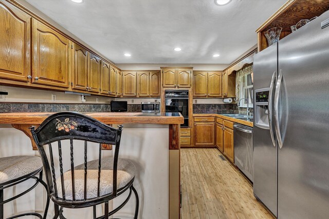 113 Lake Park Dr, Union Hall, VA 24176 - kitchen with a sink, light wood finished floors, brown cabinets, stainless steel appliances, and recessed lighting