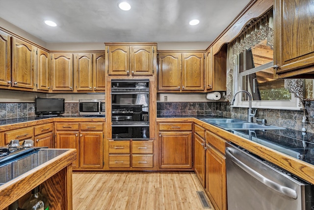 113 Lake Park Dr, Union Hall, VA 24176 - kitchen featuring a sink, appliances with stainless steel finishes, brown cabinetry, and light wood-type flooring