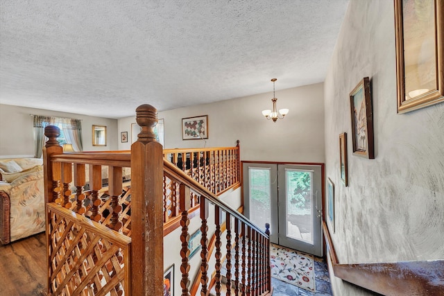 113 Lake Park Dr, Union Hall, VA 24176 - staircase featuring a notable chandelier, a textured ceiling, and wood finished floors