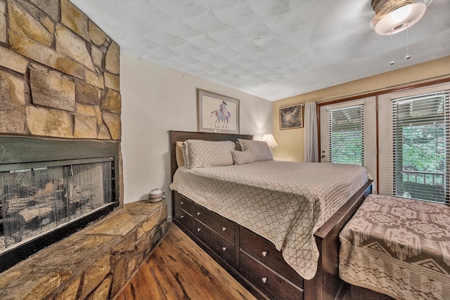 113 Lake Park Dr, Union Hall, VA 24176 - bedroom featuring a fireplace, wood finished floors, and access to exterior