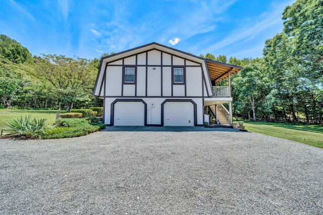 113 Lake Park Dr, Union Hall, VA 24176 - view of front of property featuring gravel driveway, a garage, stairway, a front lawn, and stucco siding