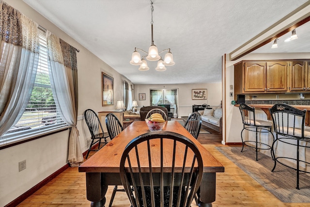 113 Lake Park Dr, Union Hall, VA 24176 - dining area featuring baseboards, light wood-type flooring, and an inviting chandelier
