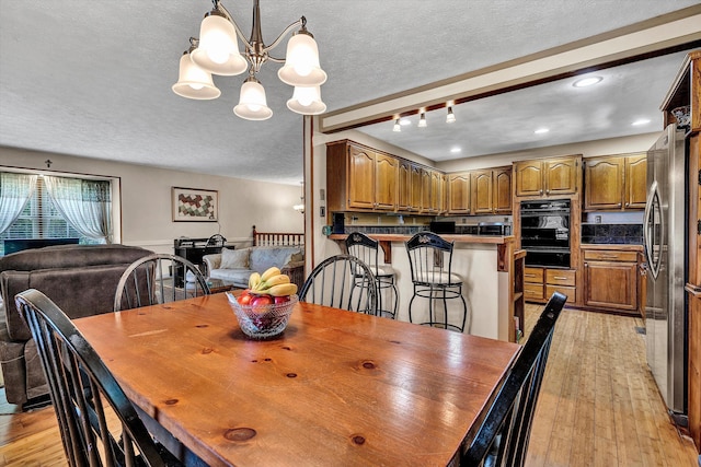 113 Lake Park Dr, Union Hall, VA 24176 - dining space featuring a notable chandelier, light wood-style floors, recessed lighting, and a textured ceiling