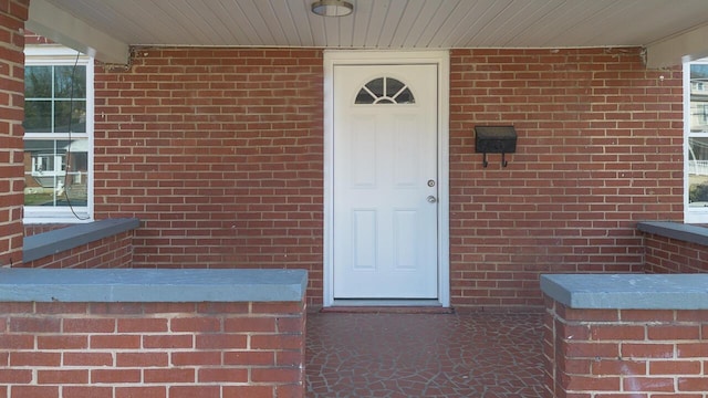 property entrance featuring brick siding