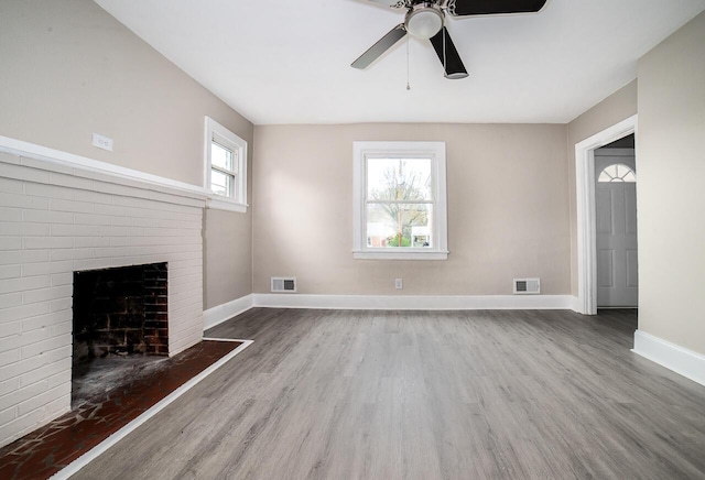 unfurnished living room featuring a ceiling fan, wood finished floors, baseboards, and visible vents