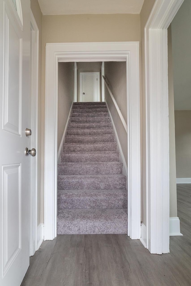 stairs with baseboards and wood finished floors