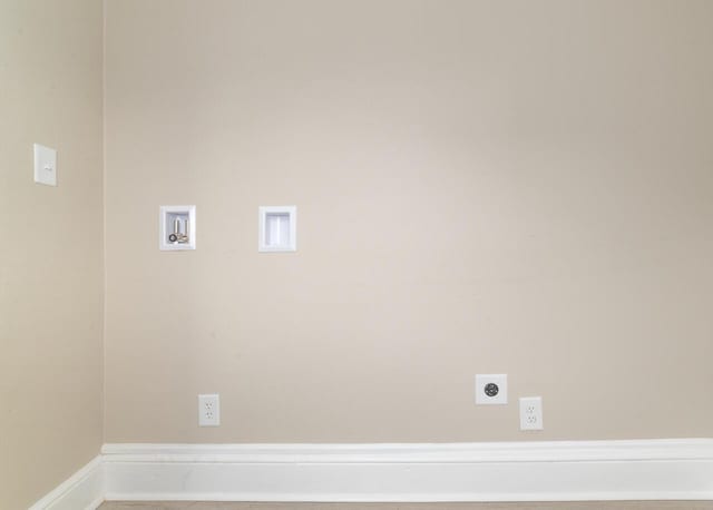 clothes washing area with hookup for a washing machine, hookup for an electric dryer, baseboards, and laundry area