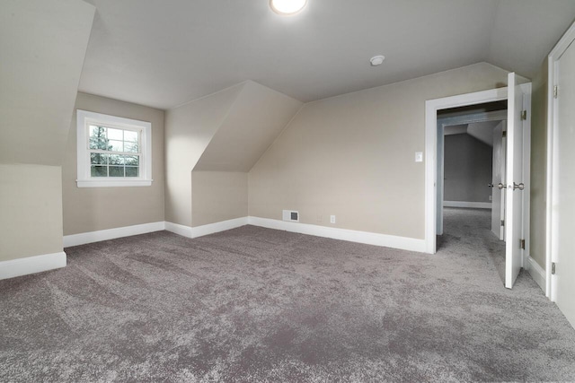 bonus room featuring baseboards, carpet flooring, lofted ceiling, and visible vents