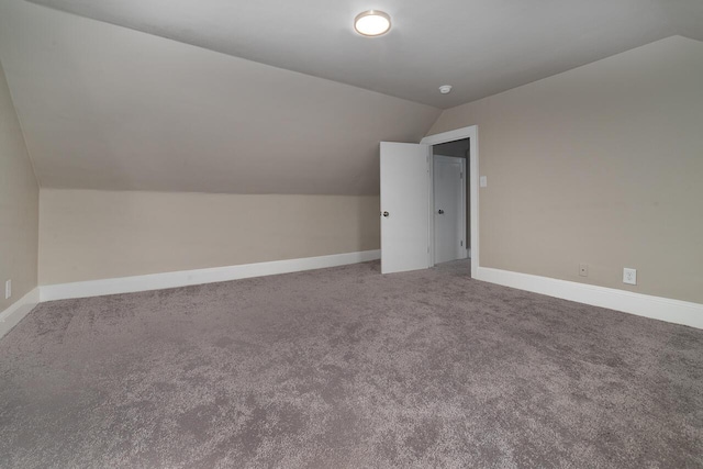 bonus room featuring baseboards, carpet floors, and vaulted ceiling