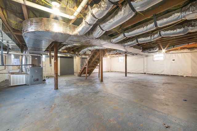 basement featuring electric panel and stairway