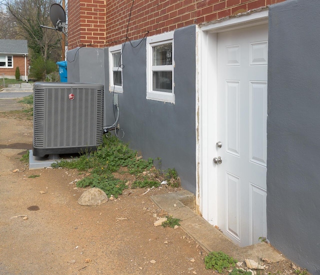 details featuring brick siding and central AC unit