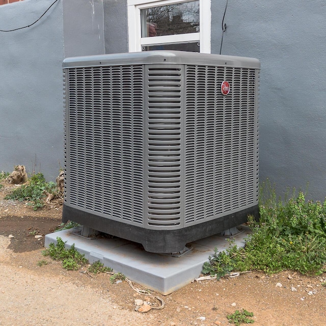 details featuring cooling unit and stucco siding