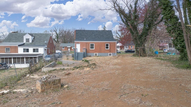 rear view of property with fence