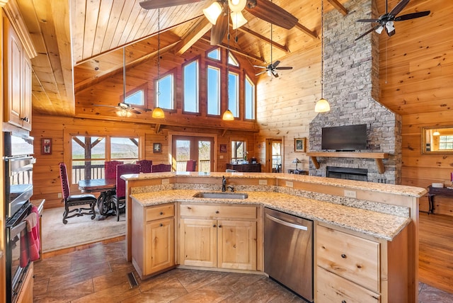 kitchen with open floor plan, a ceiling fan, a sink, and appliances with stainless steel finishes