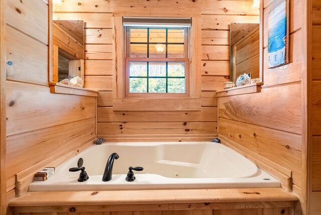 full bathroom featuring a jetted tub and wooden walls