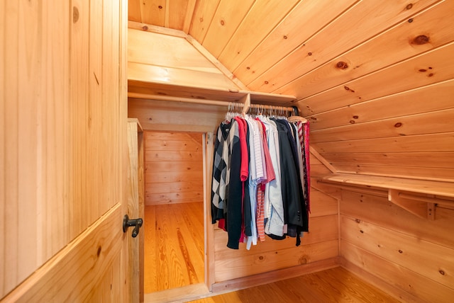 spacious closet with lofted ceiling and wood finished floors