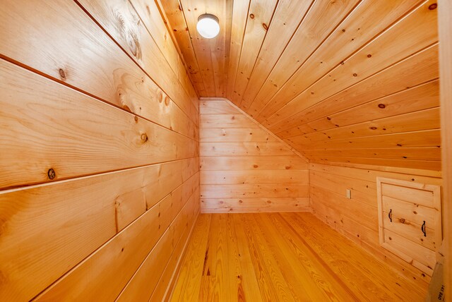 bonus room with vaulted ceiling, wood ceiling, wood finished floors, wood walls, and a sauna