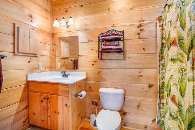 full bathroom with toilet, vanity, curtained shower, and wood walls