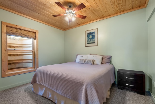 carpeted bedroom with baseboards, a ceiling fan, crown molding, and wooden ceiling