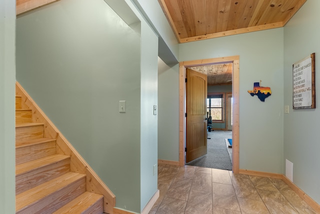 stairway with wood ceiling and baseboards