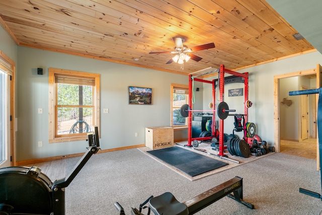 workout area featuring baseboards, ceiling fan, wooden ceiling, and carpet floors