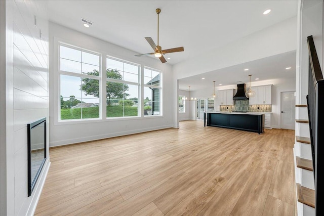 1050 Westerham Ct, Huddleston, VA 24104 - unfurnished living room with ceiling fan, a fireplace, healthy amount of natural light, light wood-type flooring, and recessed lighting
