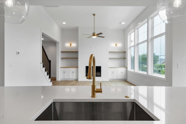 1050 Westerham Ct, Huddleston, VA 24104 - kitchen featuring a sink, built in features, ceiling fan, recessed lighting, and wood finished floors