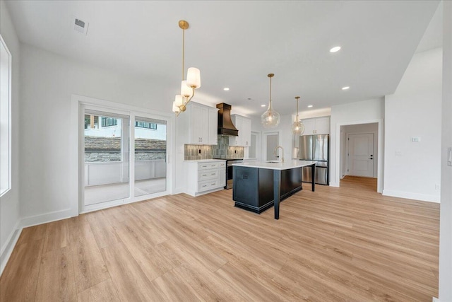 1050 Westerham Ct, Huddleston, VA 24104 - kitchen with appliances with stainless steel finishes, custom range hood, light wood-style floors, light countertops, and a breakfast bar area
