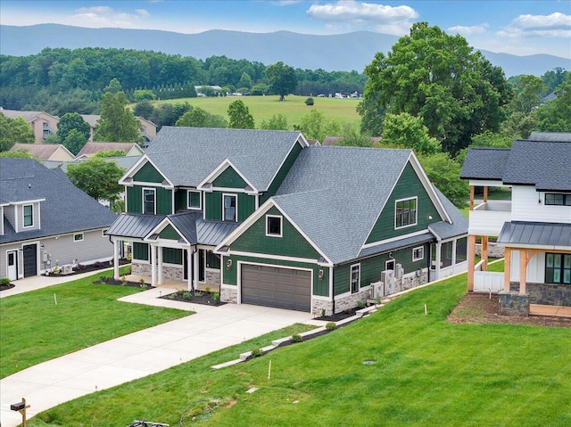 1050 Westerham Ct, Huddleston, VA 24104 - view of front of home with stone siding, a mountain view, a standing seam roof, driveway, and covered porch