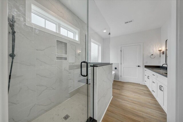 1050 Westerham Ct, Huddleston, VA 24104 - full bathroom featuring a marble finish shower, a soaking tub, vanity, wood finished floors, and recessed lighting