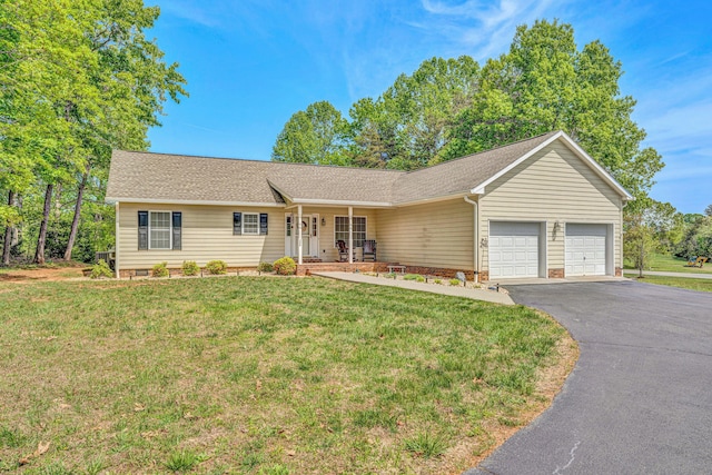 ranch-style home with covered porch, a front lawn, driveway, and an attached garage