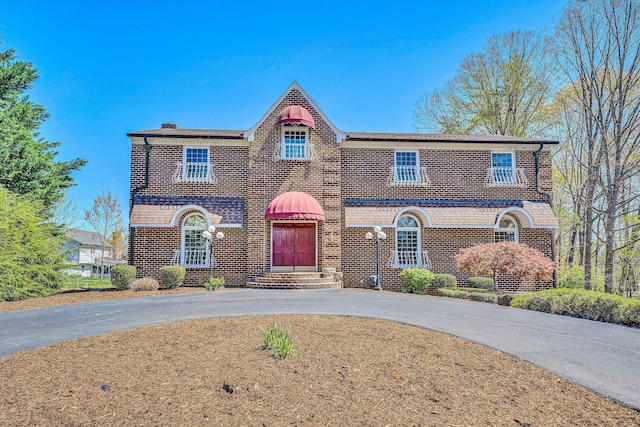 1710 Dawn Ln SW, Roanoke, VA 24018 - view of front of house with brick siding, driveway, and a chimney