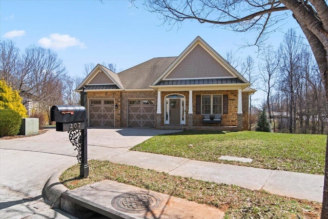 craftsman-style house with a standing seam roof, metal roof, a front lawn, an attached garage, and concrete driveway