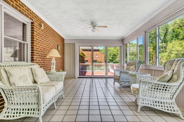 sunroom / solarium featuring plenty of natural light, ceiling fan, and an outdoor living space