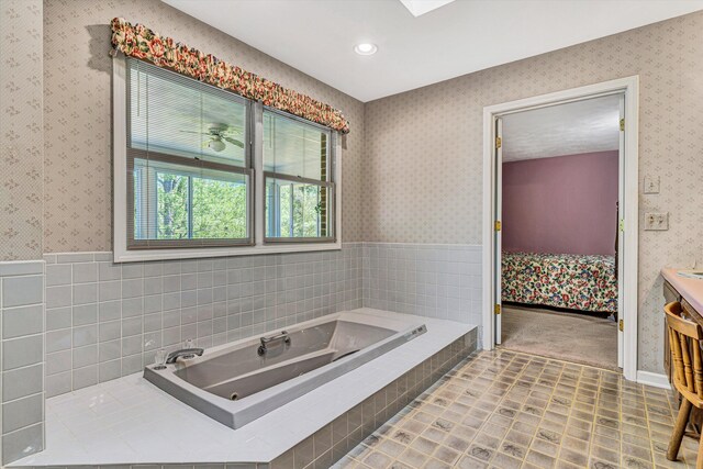 ensuite bathroom with a bath, wainscoting, ensuite bath, and wallpapered walls