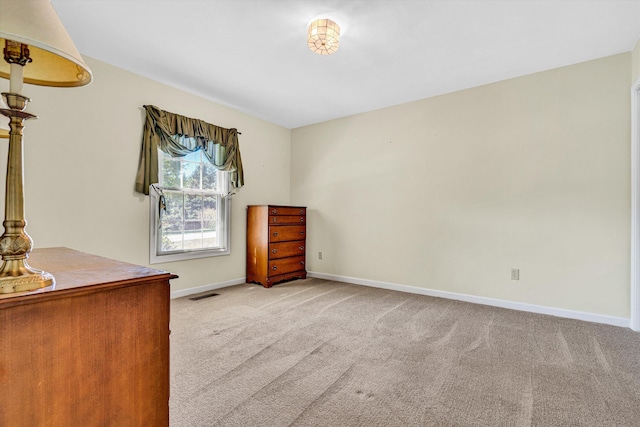 bedroom with baseboards, visible vents, and carpet