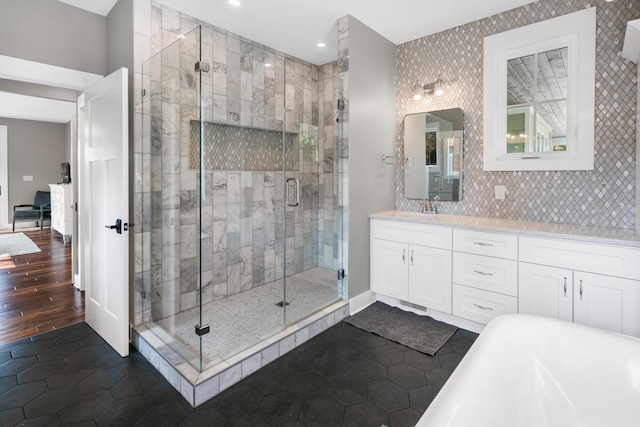 bathroom with vanity, tile patterned flooring, a stall shower, and a soaking tub