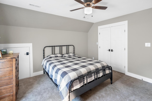 bedroom with carpet, a closet, a ceiling fan, visible vents, and lofted ceiling