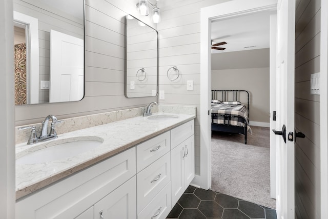 full bathroom with tile patterned floors, double vanity, a sink, and a ceiling fan