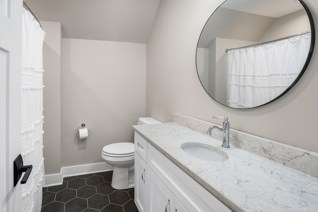 full bath with vanity, baseboards, tile patterned floors, toilet, and lofted ceiling