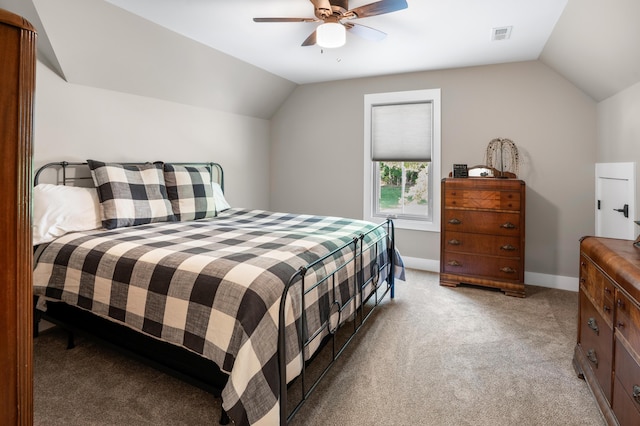 bedroom featuring ceiling fan, light colored carpet, baseboards, and lofted ceiling