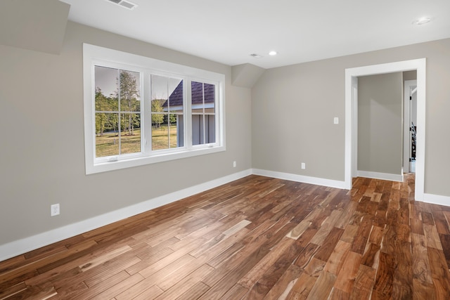 empty room with recessed lighting, dark wood-style floors, baseboards, and visible vents